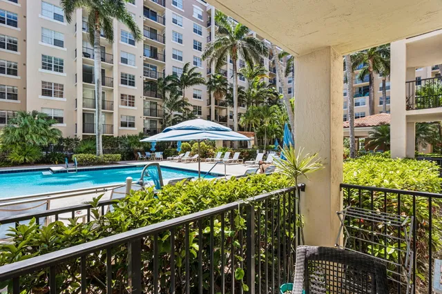 a view of a porch with a table and chair under an umbrella