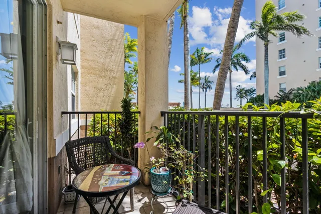 a view of a balcony with chairs and table
