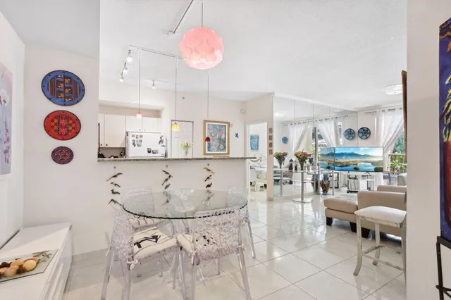 a living room with furniture and kitchen view