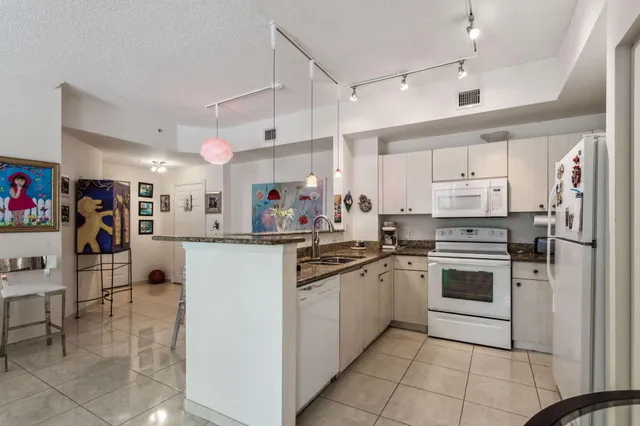 a kitchen with cabinets and stainless steel appliances