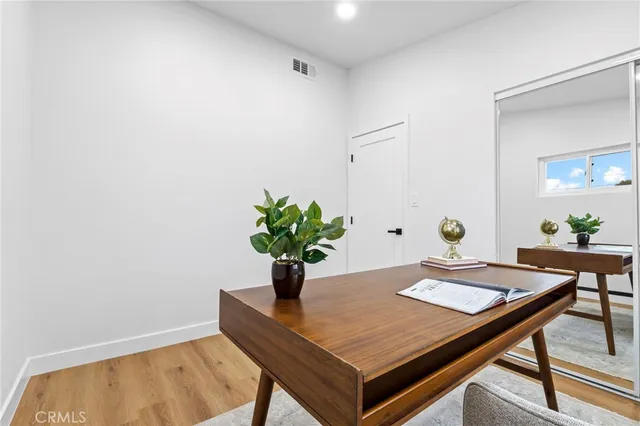 a view of a room with furniture and wooden floor