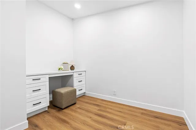 a spacious bedroom with a bed and a potted plant