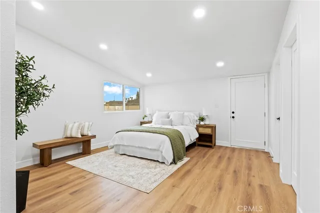 a bedroom with a bed and a potted plant