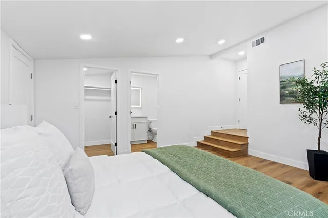 a bathroom with a granite countertop toilet a sink and a shower