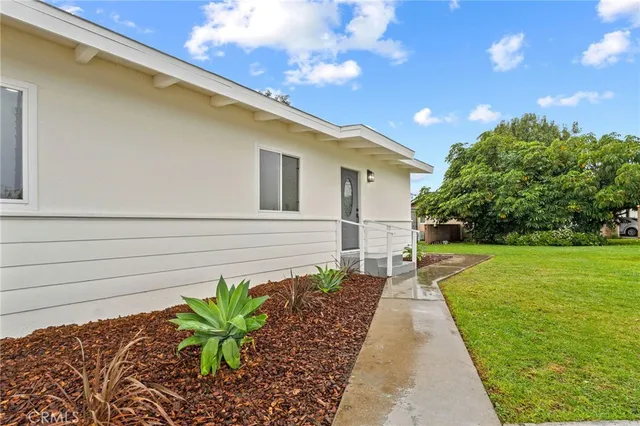 a view of backyard of house and trees