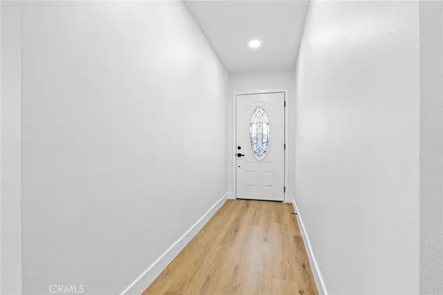 a view of a room with wooden floor and bathroom