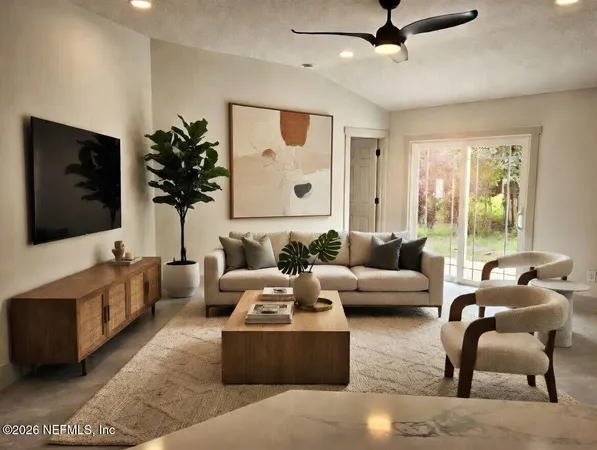 a living room with furniture and a flat screen tv