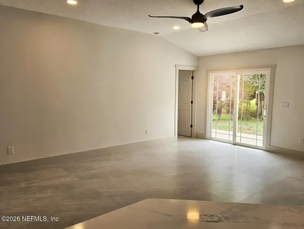 a view of an empty room with a window