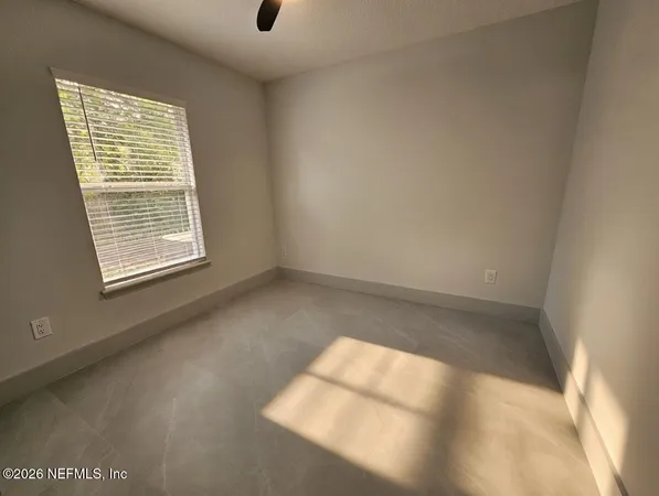 a view of an empty room and a window