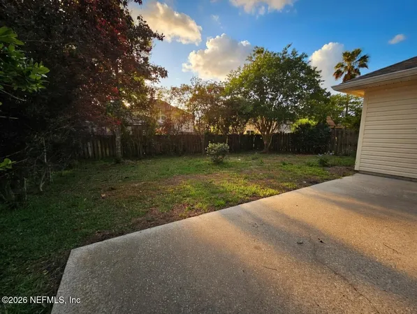 a view of a yard with basketball court
