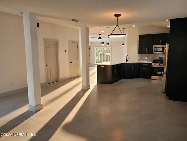 a kitchen with stainless steel appliances granite countertop a refrigerator and a sink