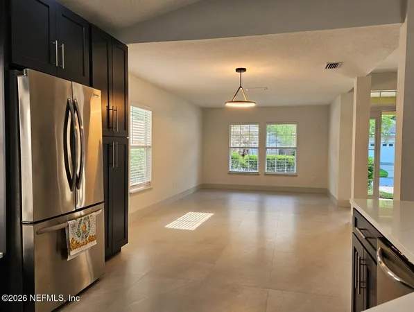 a view of a kitchen with a refrigerator cabinets and a window