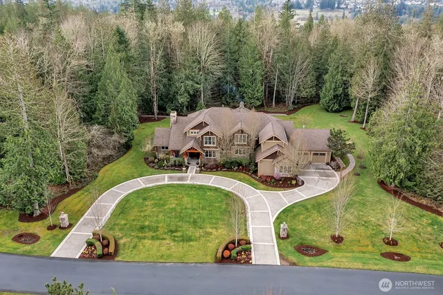 an aerial view of a house with swimming pool patio and lake view