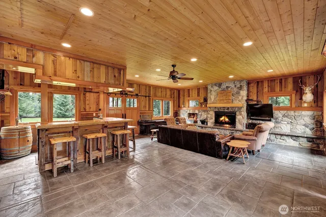 a living room with lots of furniture and kitchen view