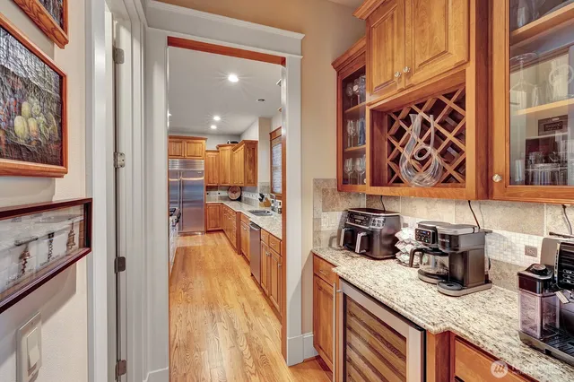 a kitchen with stainless steel appliances granite countertop a sink a stove and cabinets