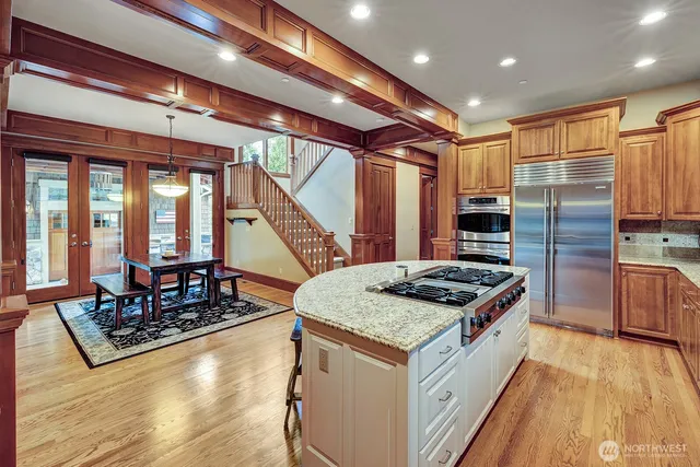 a kitchen with stainless steel appliances granite countertop a stove and a refrigerator