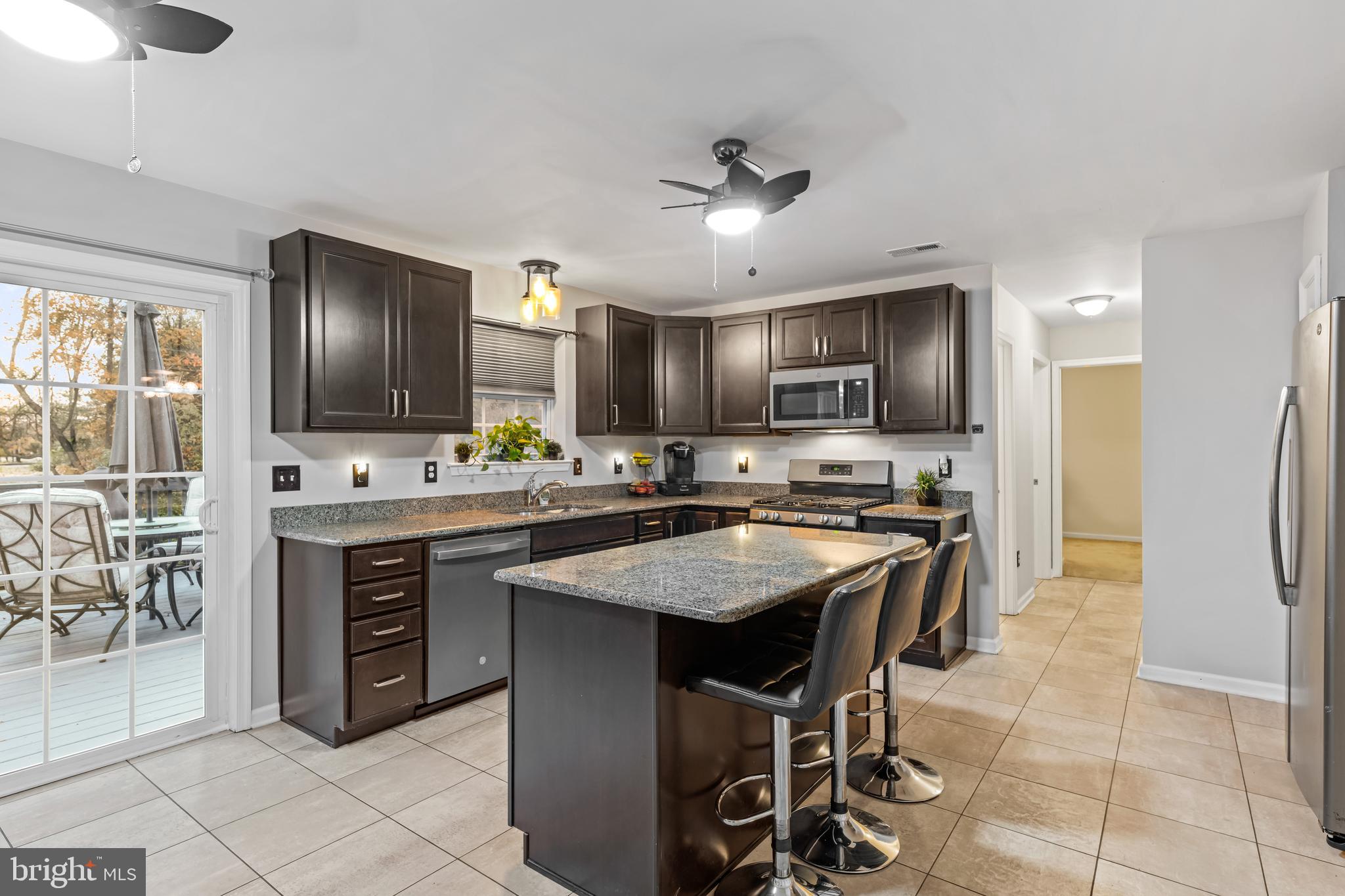 108 Nottingham Lane Newfield, NJ 08344 - Photo 22 of 39 a kitchen with stainless steel appliances granite countertop a stove top oven a sink refrigerator and cabinets