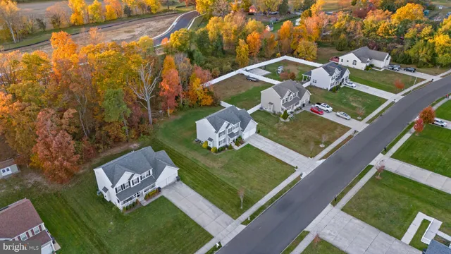 an aerial view of a house with garden space and street view