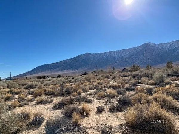 a view of a large mountain with mountains in the background