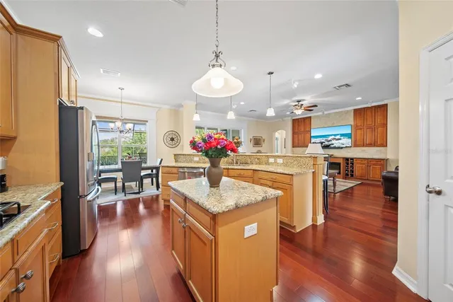 a kitchen with stainless steel appliances granite countertop counter space and wooden floor