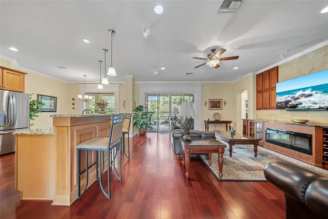 a living room with furniture fireplace and wooden floor