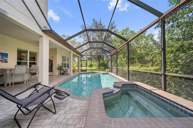 a view of swimming pool with a couches and chairs