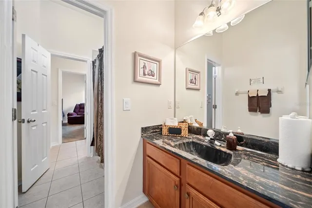 a en suite bathroom with a double vanity sink and a mirror