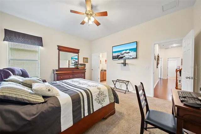 a bedroom with a bed a desk and chair