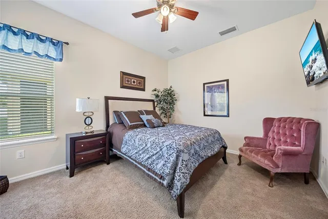 a bedroom with a bed and a couch