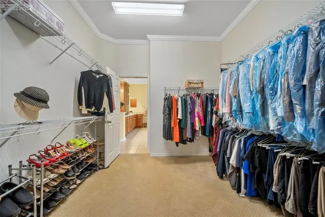 a view of walk in closet with clothes