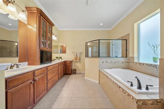 a large bathroom with a double vanity sink large mirror and bathtub