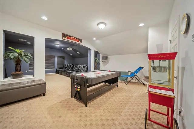 a living room with patio furniture and kitchen view