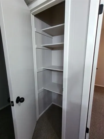a view of an empty walk in closet