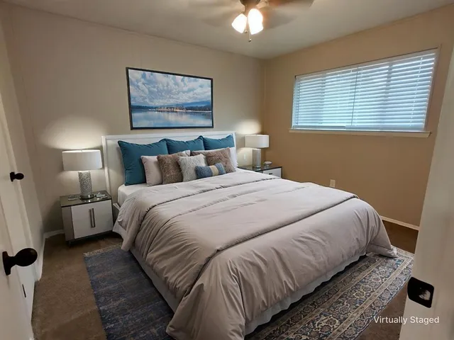 a bedroom with bed and a window