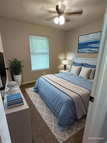 a bedroom with a large bed and a window