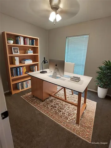 a workspace with furniture bookshelf and a window