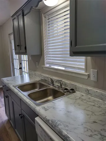 a kitchen that has a sink and cabinets
