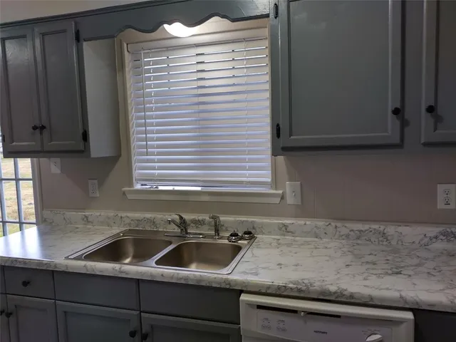 a kitchen with a sink and cabinets