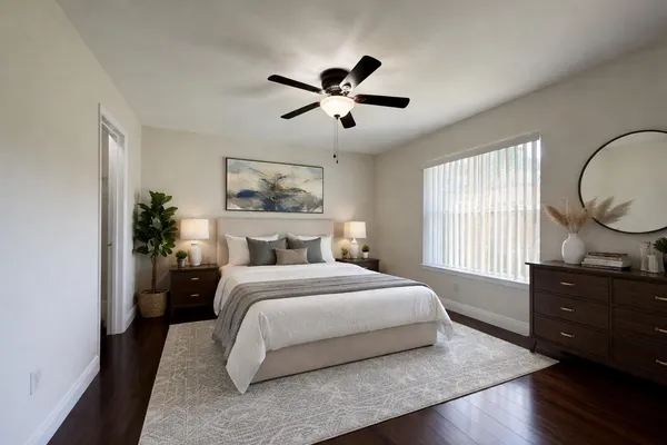 a bedroom with a large bed and a window