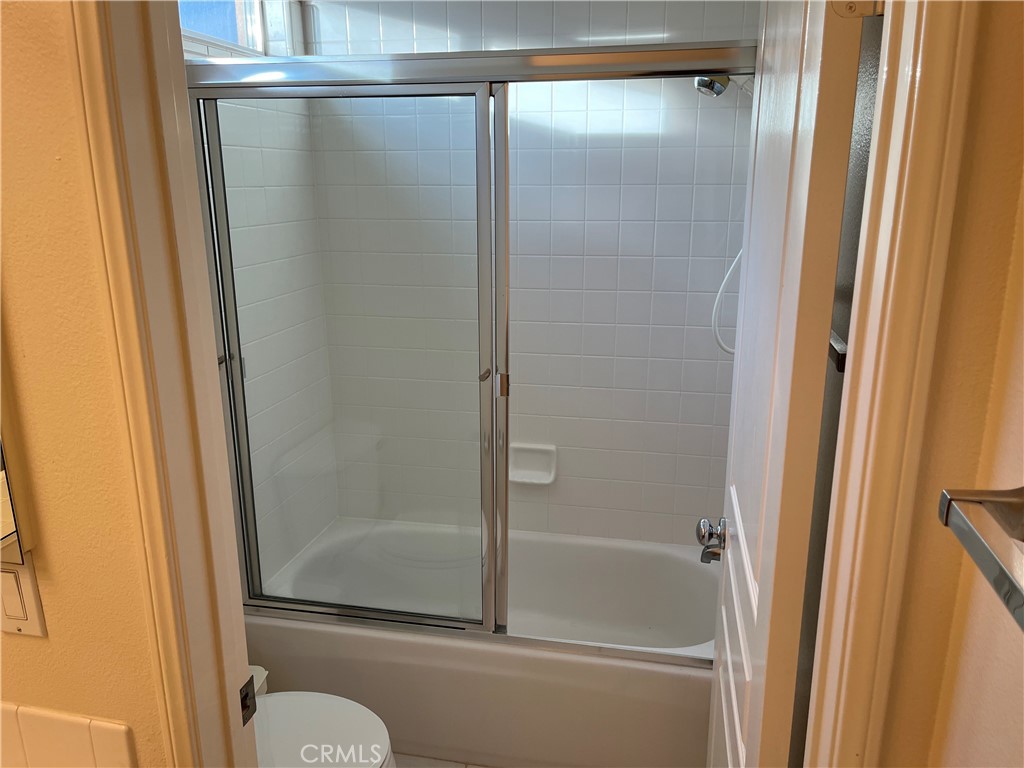 39 Avanzare Irvine, CA 92606 - Photo 16 of 16 a bathroom with a glass shower door