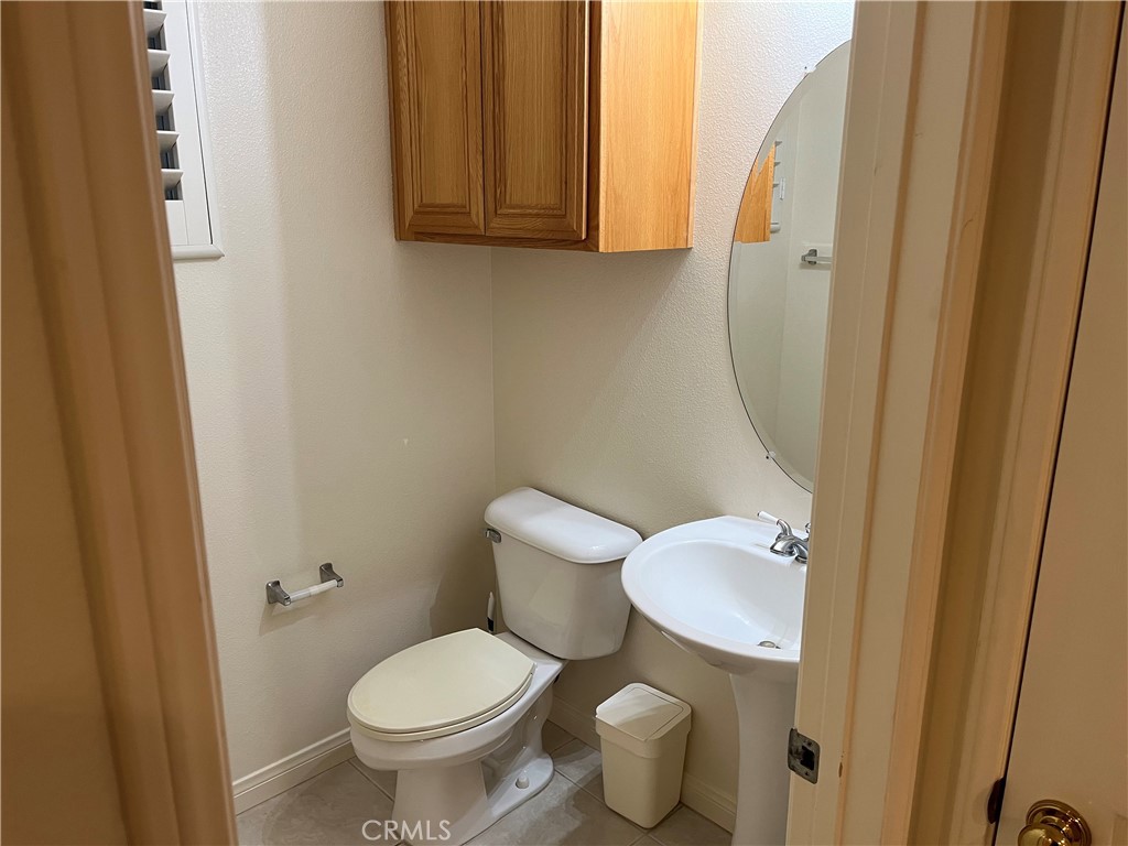 39 Avanzare Irvine, CA 92606 - Photo 5 of 16 a white toilet sitting next to a small bathroom