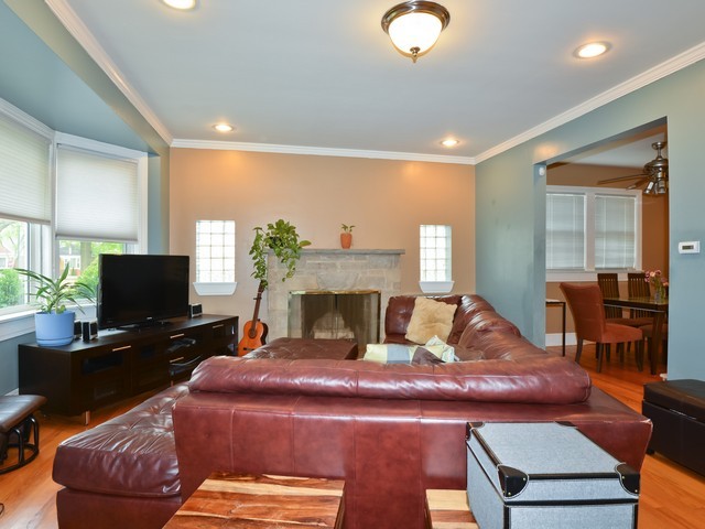 6015 West Barry Avenue Chicago, IL 60634 - Photo 2 of 10 a living room with furniture a flat screen tv and a fireplace
