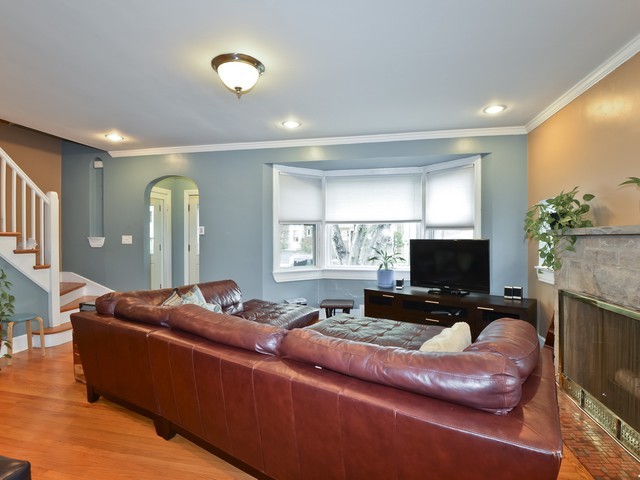 6015 West Barry Avenue Chicago, IL 60634 - Photo 3 of 10 a living room with furniture and a flat screen tv