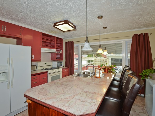 6015 West Barry Avenue Chicago, IL 60634 - Photo 5 of 10 a kitchen with stainless steel appliances granite countertop a stove and refrigerator
