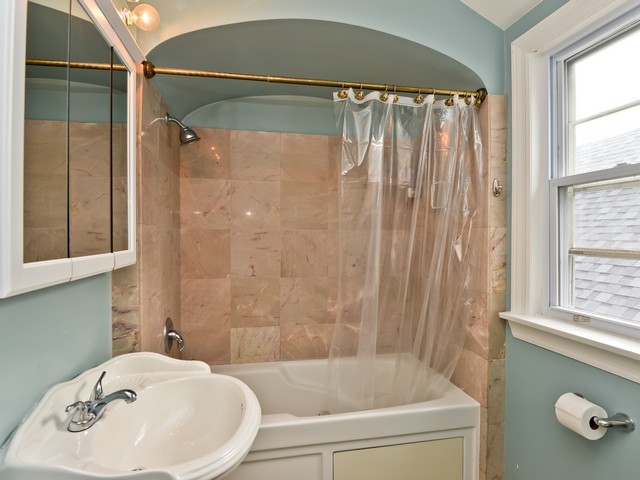 6015 West Barry Avenue Chicago, IL 60634 - Photo 7 of 10 a bathroom with a sink and a bathtub
