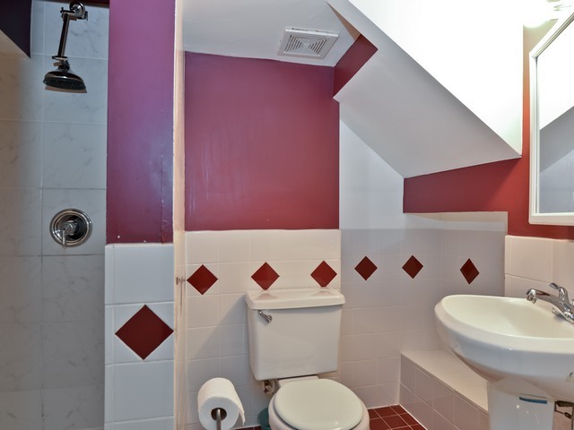 6015 West Barry Avenue Chicago, IL 60634 - Photo 8 of 10 a bathroom with a toilet sink and mirror