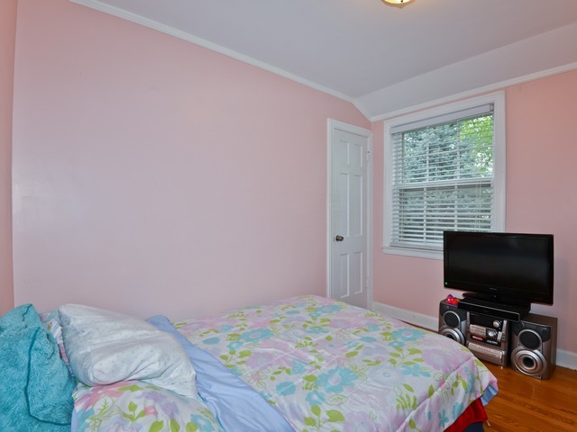 6015 West Barry Avenue Chicago, IL 60634 - Photo 9 of 10 a bedroom with a bed and a flat screen tv