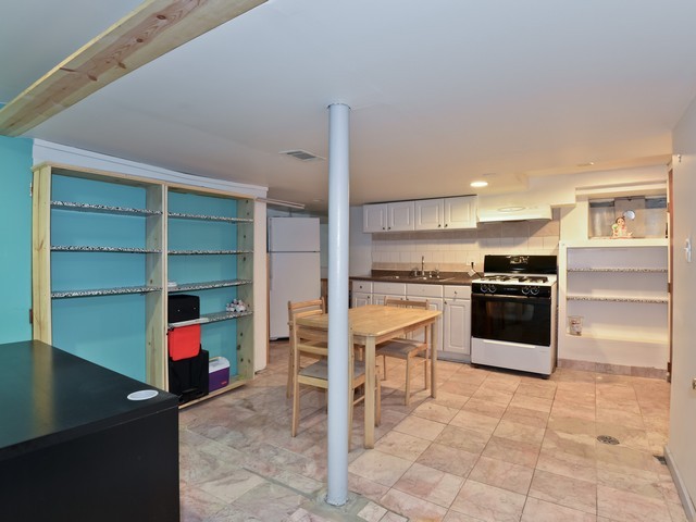 6015 West Barry Avenue Chicago, IL 60634 - Photo 10 of 10 a kitchen with granite countertop a stove and cabinets