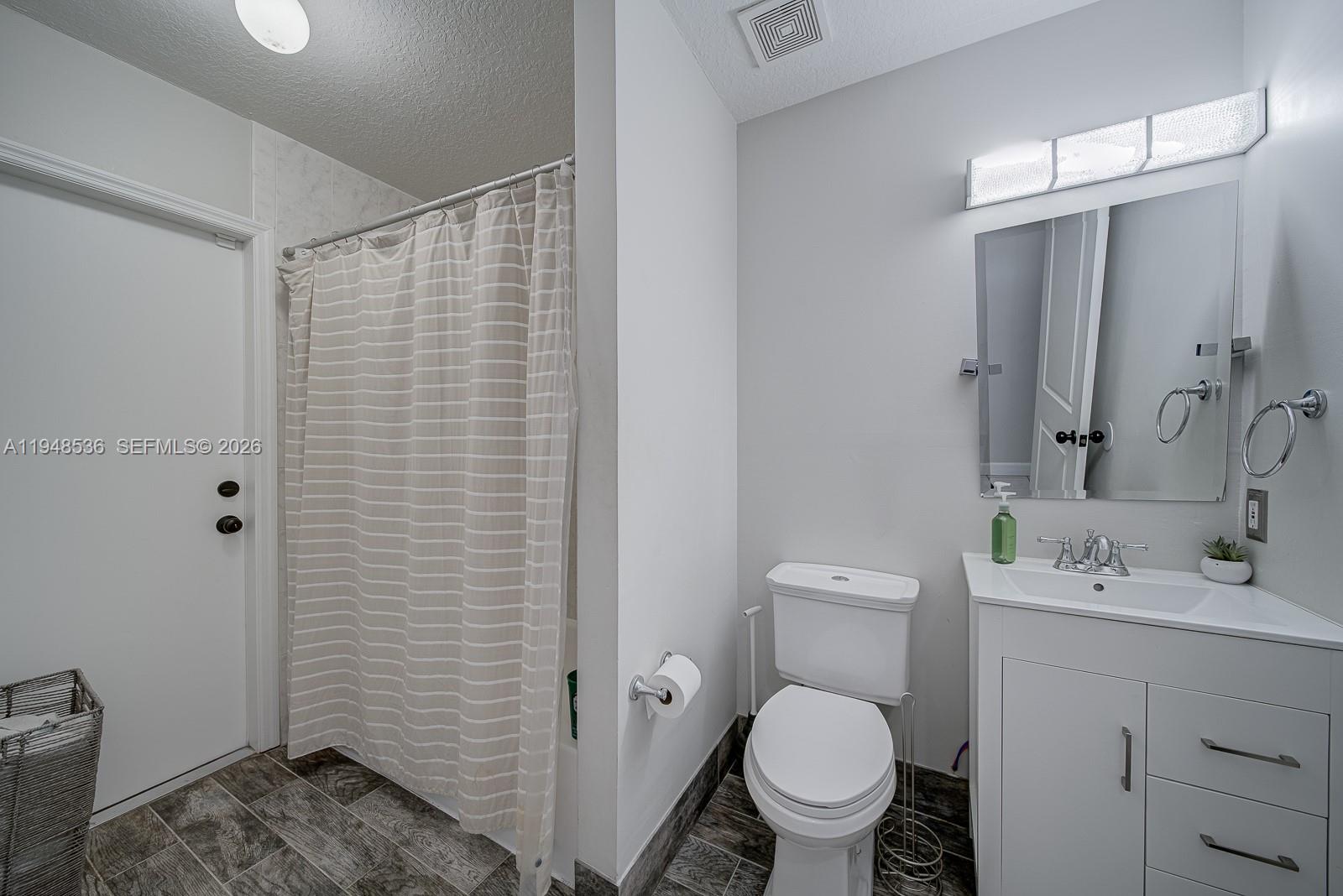 18128 Southwest 151st Avenue Miami, FL 33187 - Photo 11 of 39 a bathroom with a sink a toilet and shower
