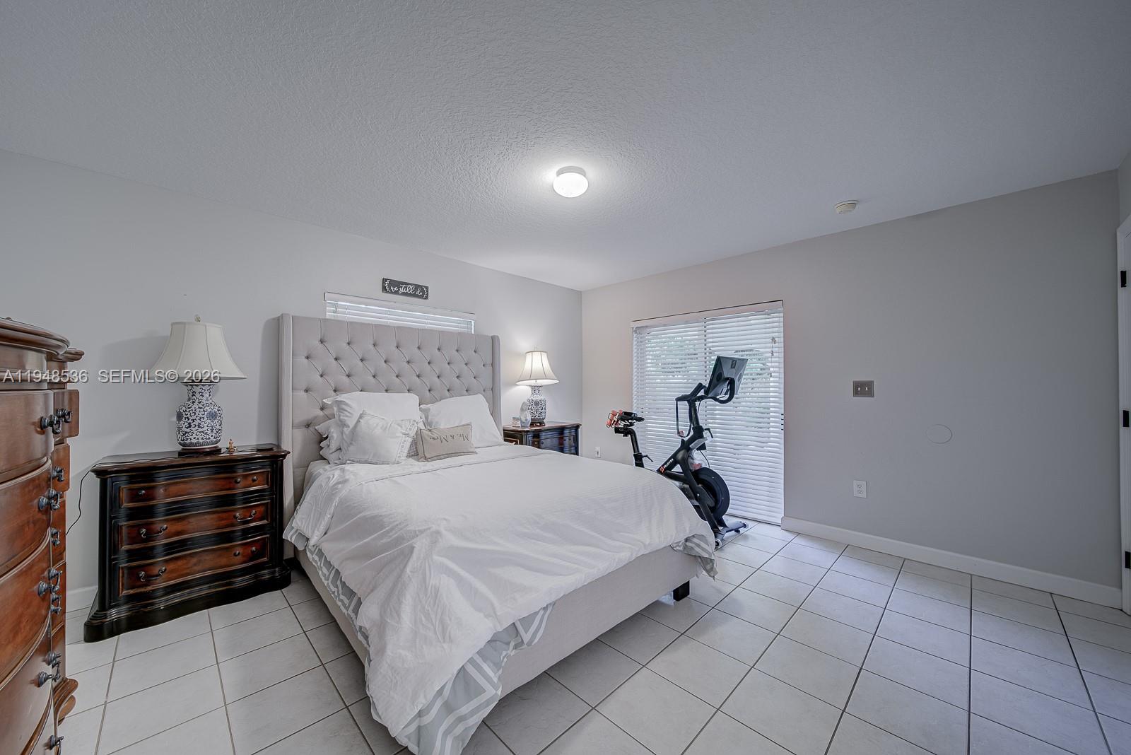 18128 Southwest 151st Avenue Miami, FL 33187 - Photo 13 of 39 a bedroom with a bed and a view of kitchen
